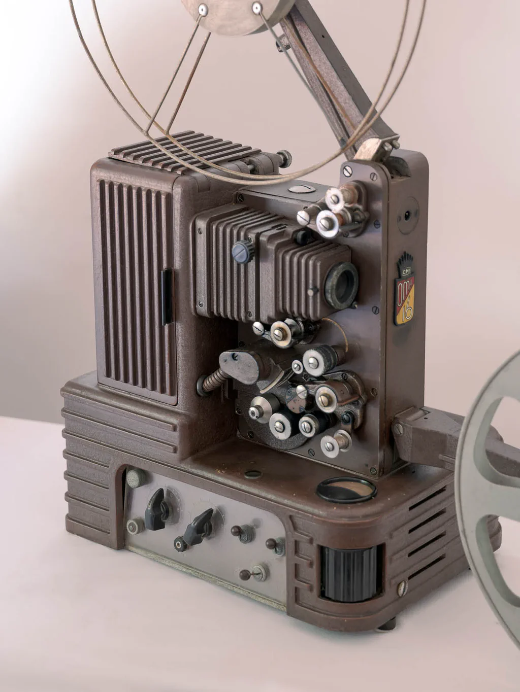 Film projector with reel arms and control knobs