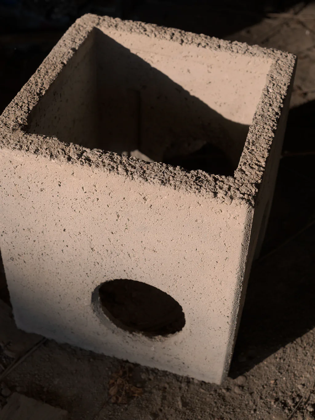 Hollow concrete block resting on the ground