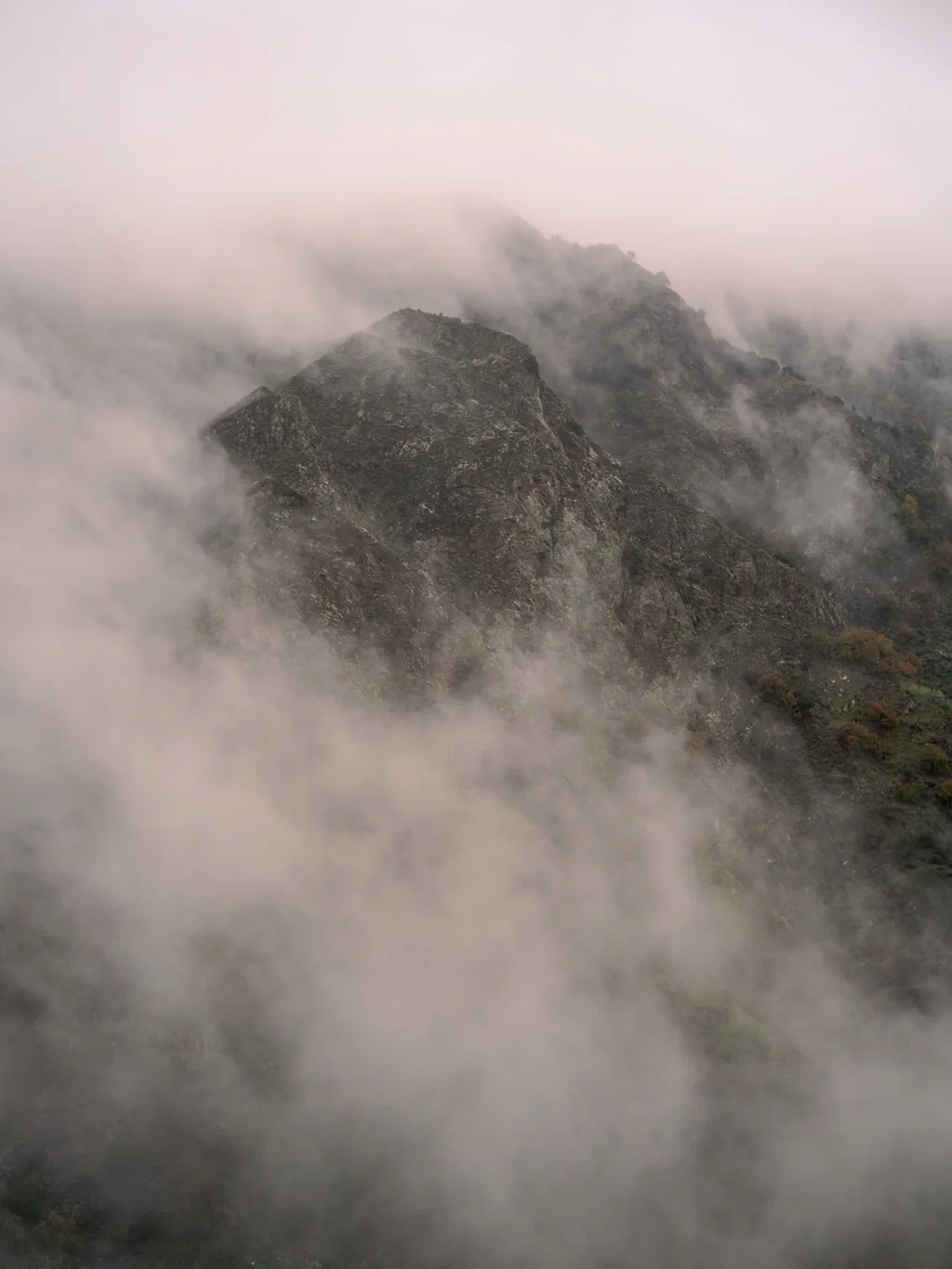 Mountain ridge emerging from low cloud