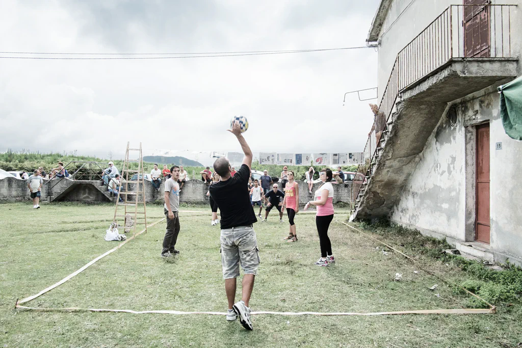 Volleyball game on the grass between houses