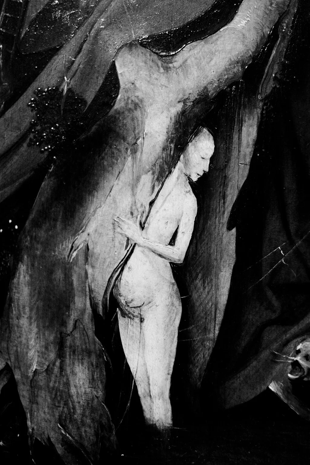 Carved wooden figure of a saint against dark drapery
