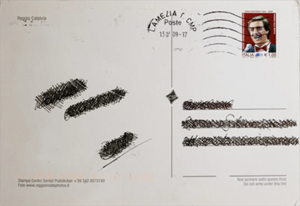 The back of an old postcard from Reggio Calabria: the message scored out in ink, the stamp and postmark left