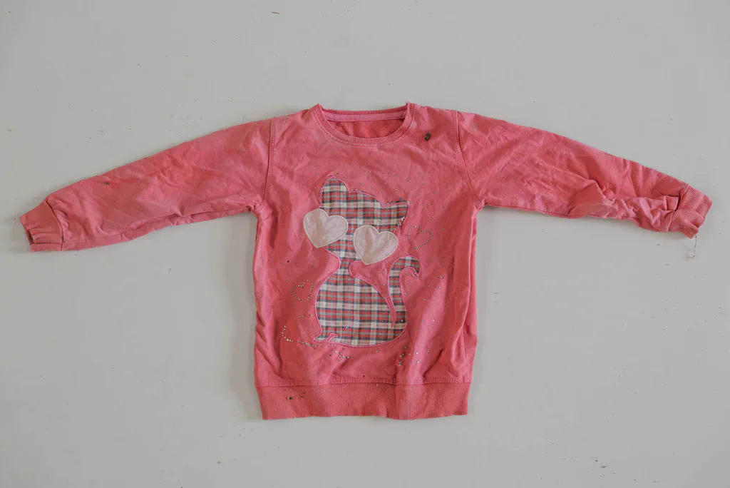 Child’s pink sweatshirt with an appliqué heart