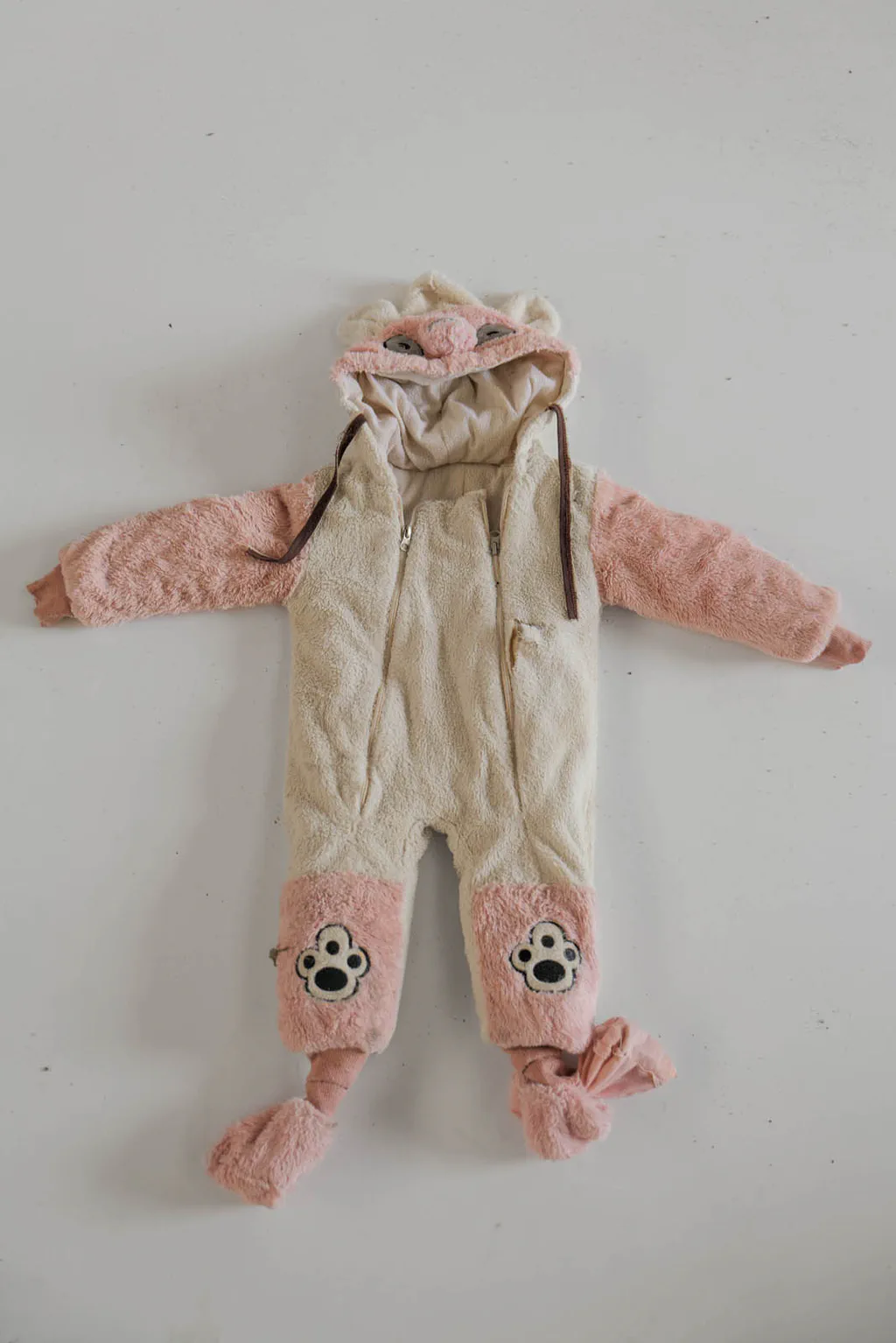 Infant’s fleece all-in-one with paw prints on the feet