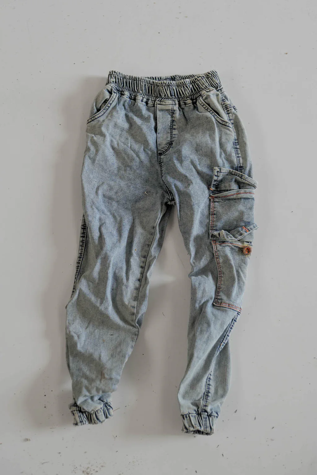 Light blue jeans, torn at the knee
