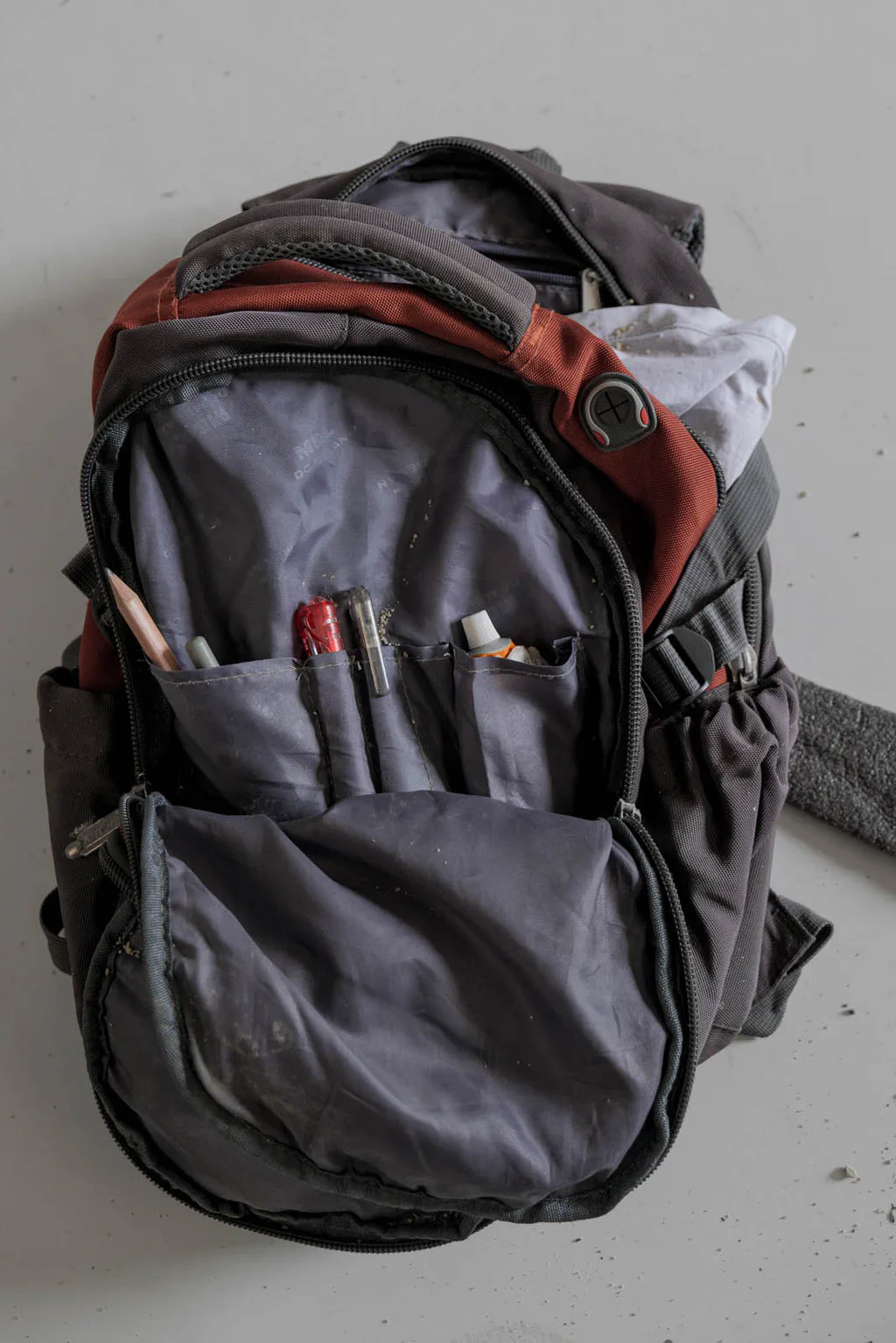 Grey backpack, pens in the front pocket