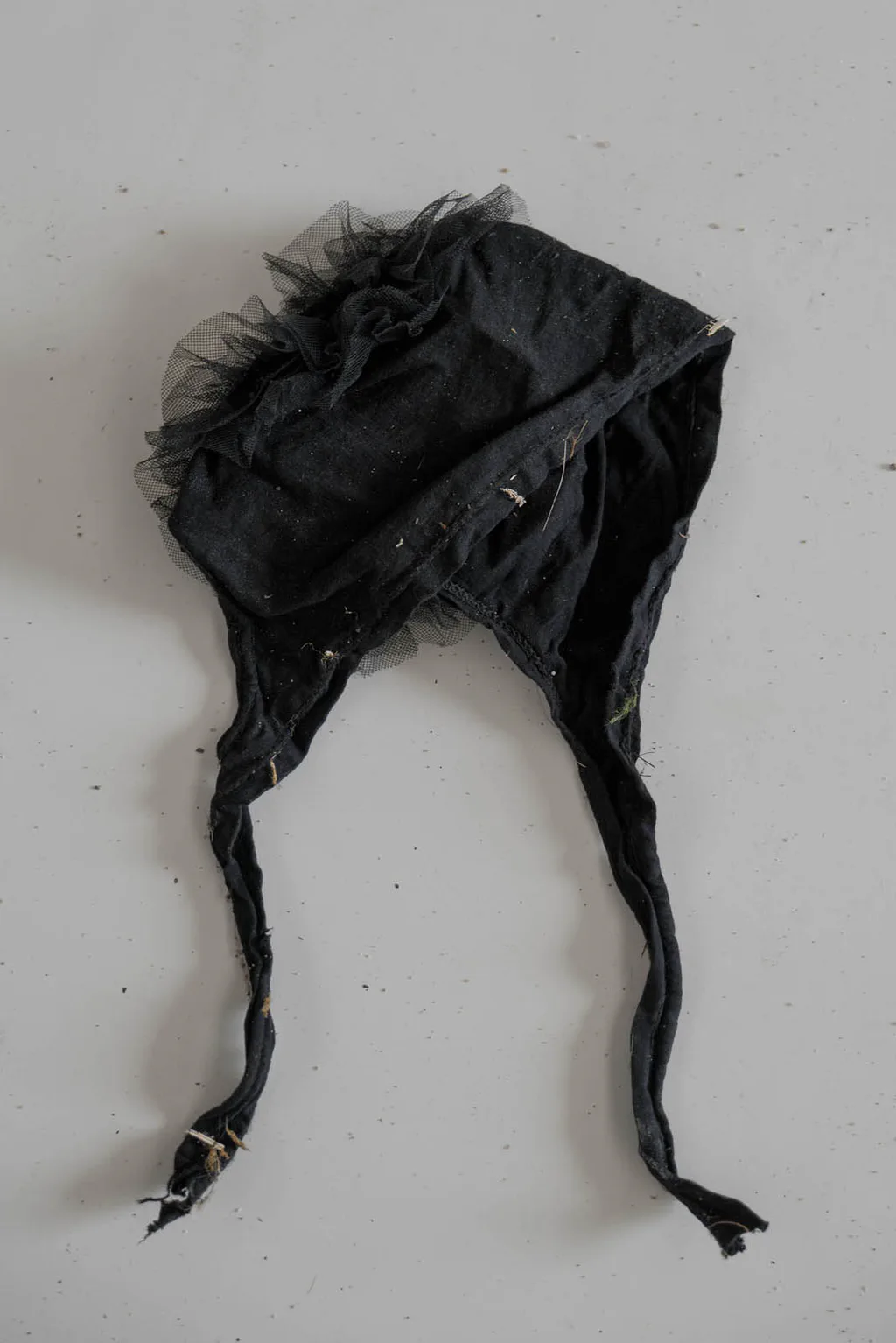 Black knitted hat with ear flaps and ties