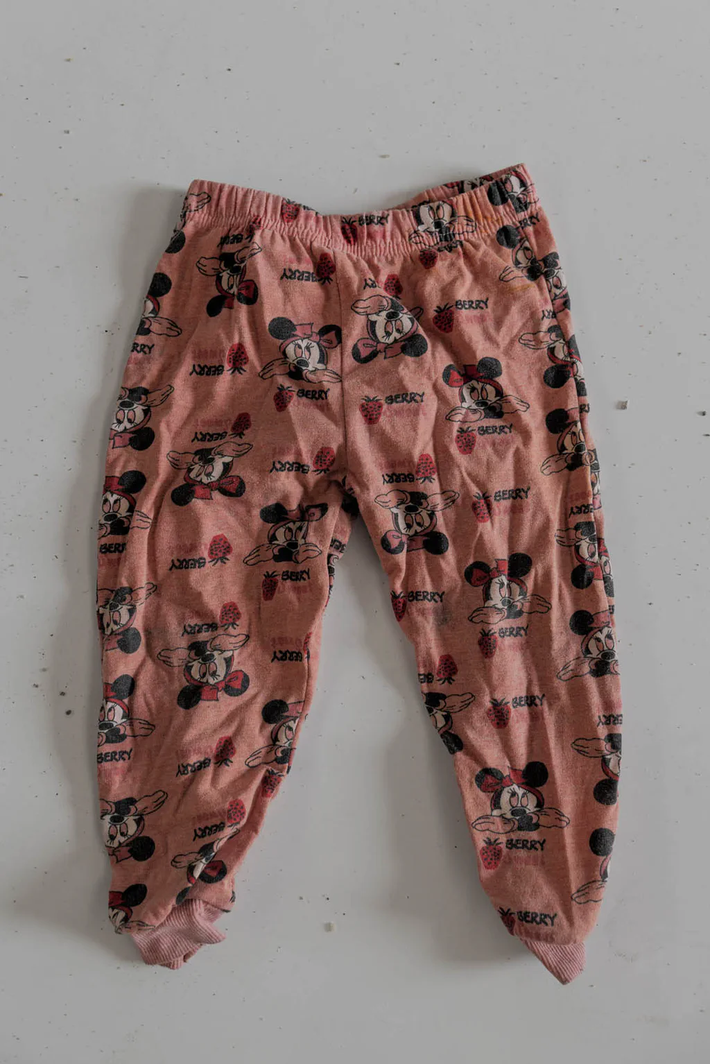 Child’s pink trousers printed with cartoon mice