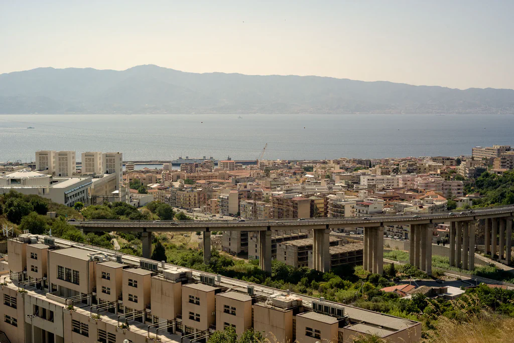 View over the city towards the Strait, an elevated road crossing the middle distance