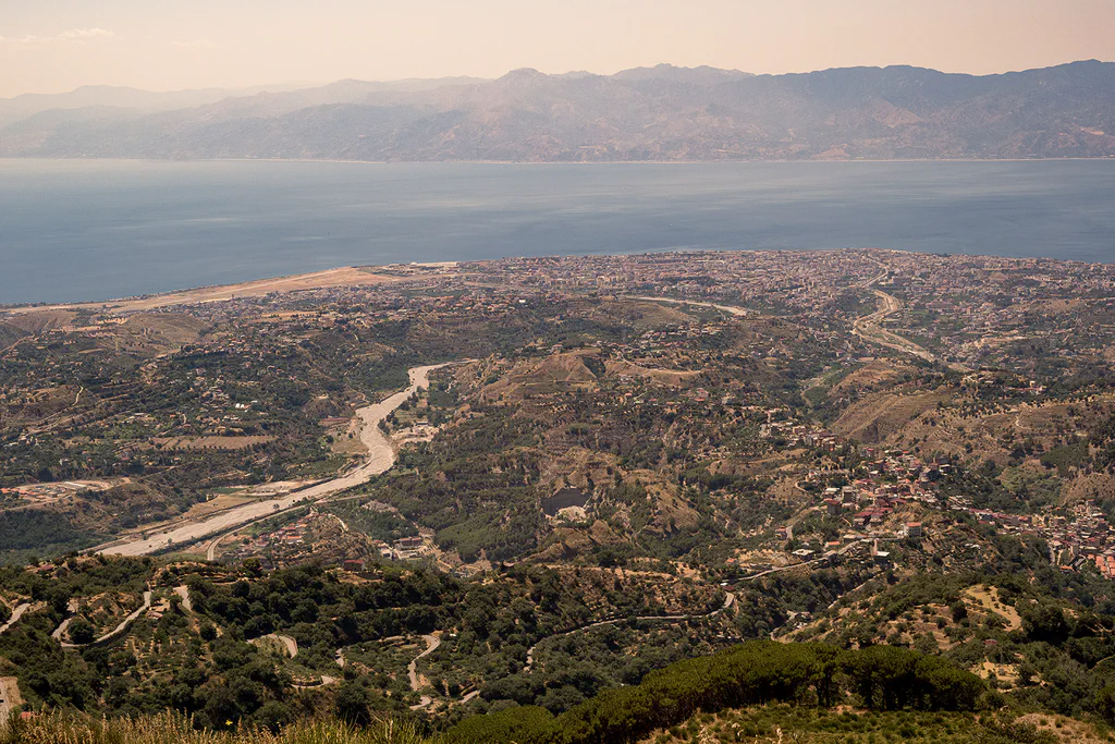 View from the mountains over the valley towards the Strait, the far coast on the horizon